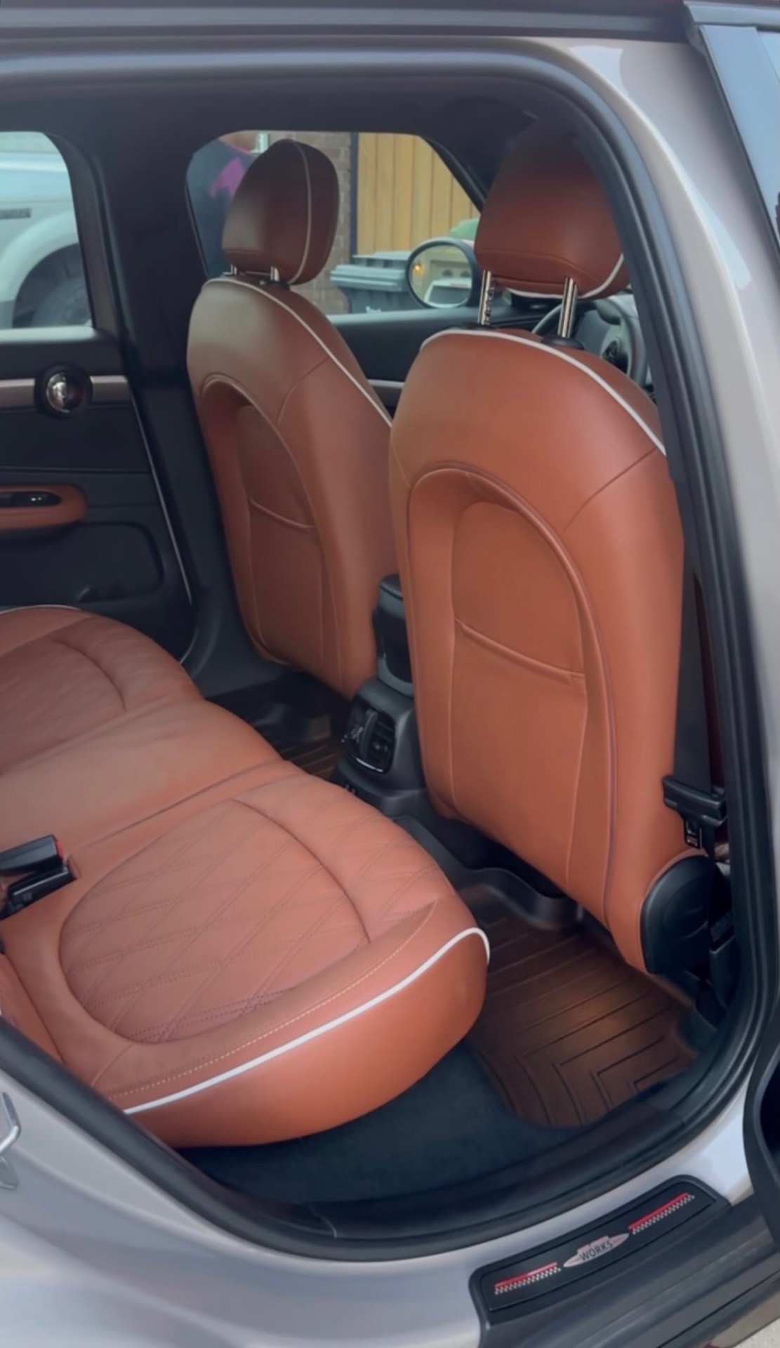 Conditioned tan leather rear seats in a Mini Cooper